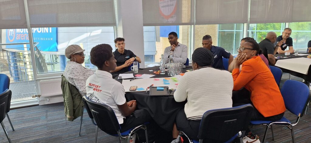 Group of sports leaders at a table talking